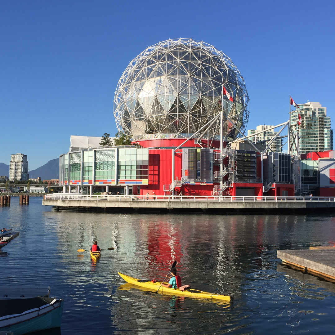 a kayak sits in False Creek with Science World in the background, Vancouver