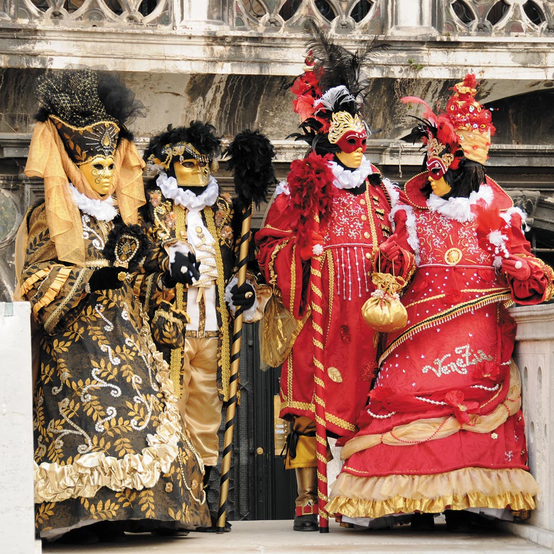 four people dressed in Carnivale costumes
