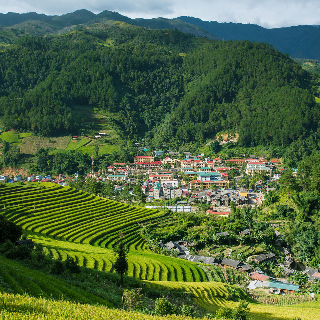 vietnamese village of sapa sits at the foot of a densely wooded Mount Fansipan