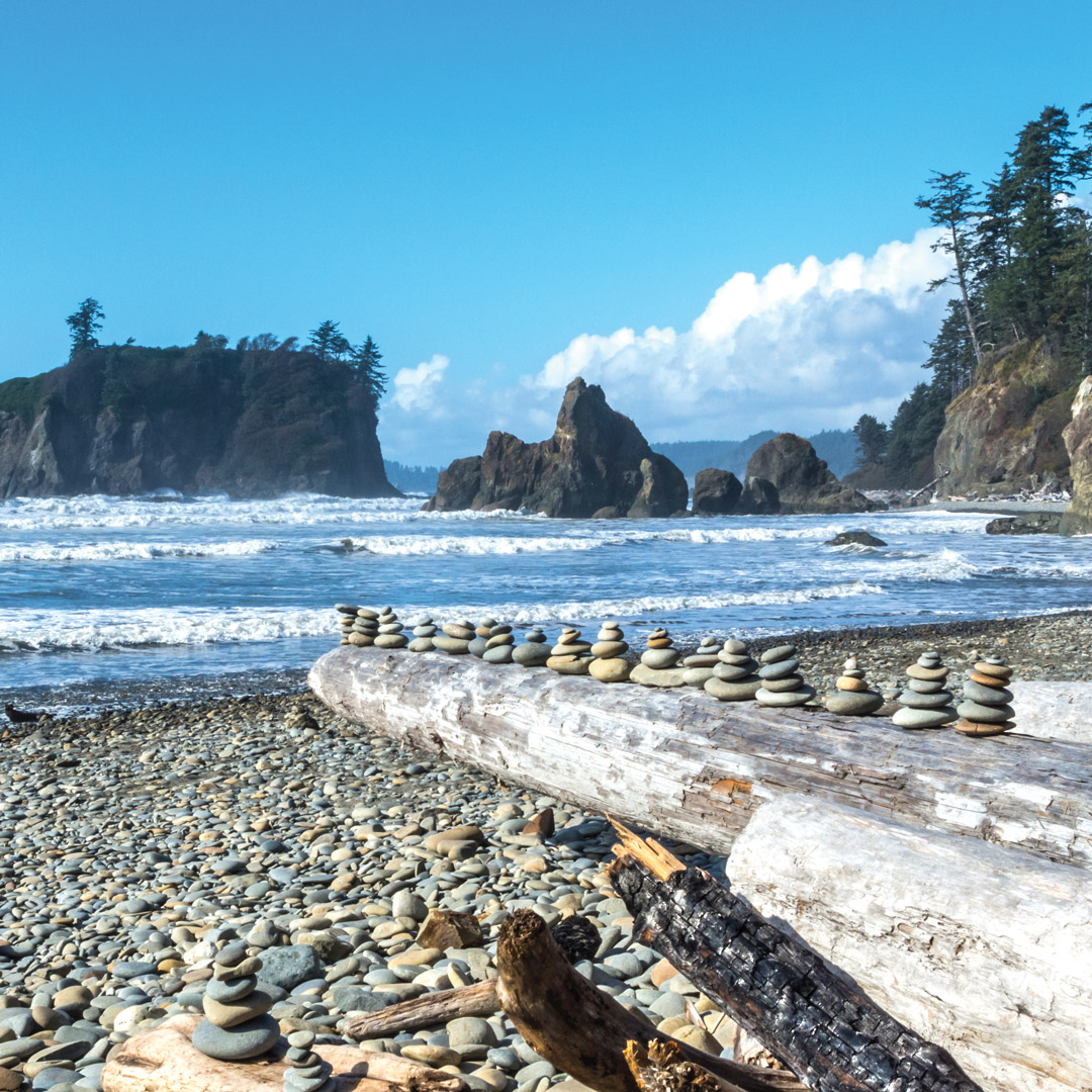 rocks stacked on a log at Ruby Beach