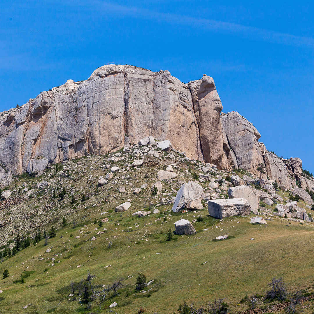 rock formation of Steamboat Point surrounded by grass