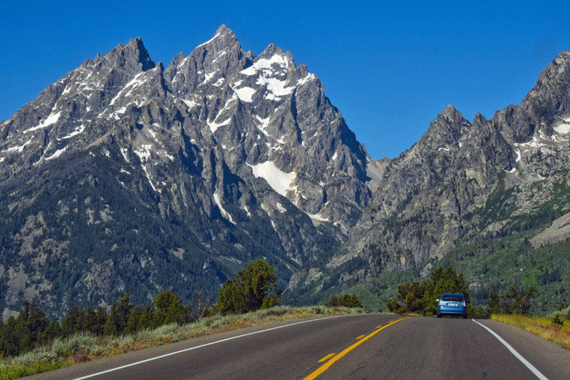 road leading to snow-dusted mountains