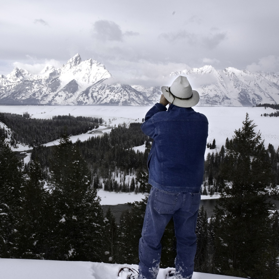 man in denim snowshoeing in grand teton national park