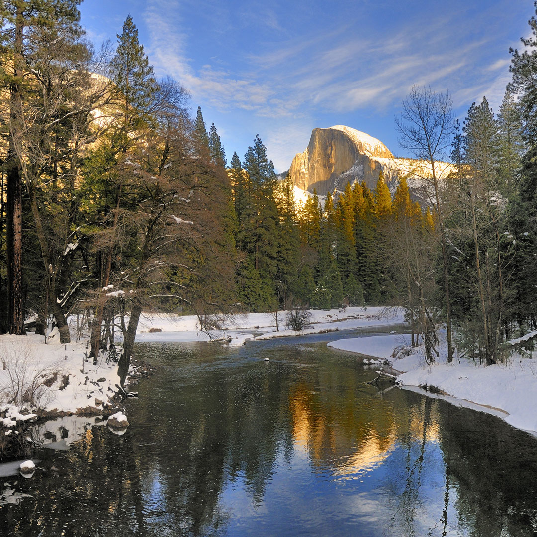 Half Dome reflecting on the merced river in Yosemite during winter