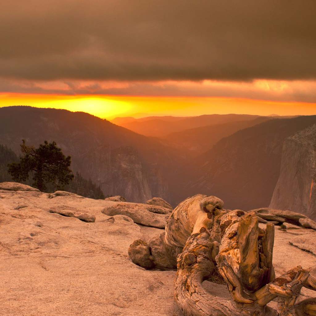 View of the sun going down from the bare rock at Sentinal Dome in Yosemite park.