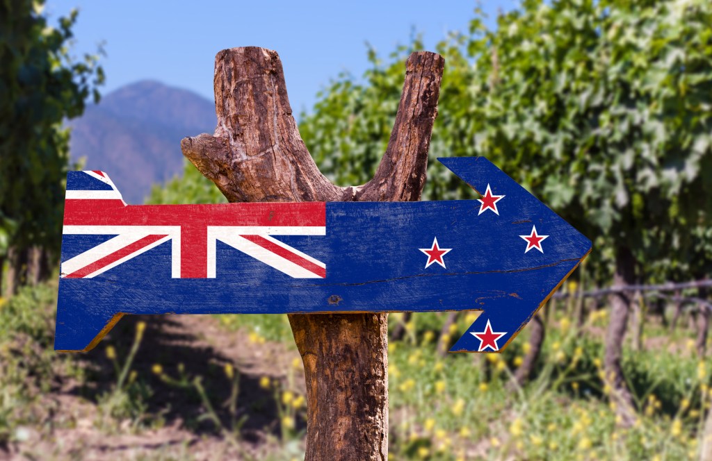 wooden sign of the New Zealand flag in a vineyard