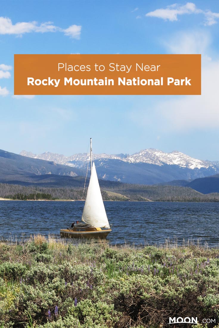 Places to Stay Near Rocky Mountain National Park text on a photo of a sailboat on Granby Lake.