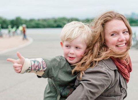 a woman carrying a child on her back