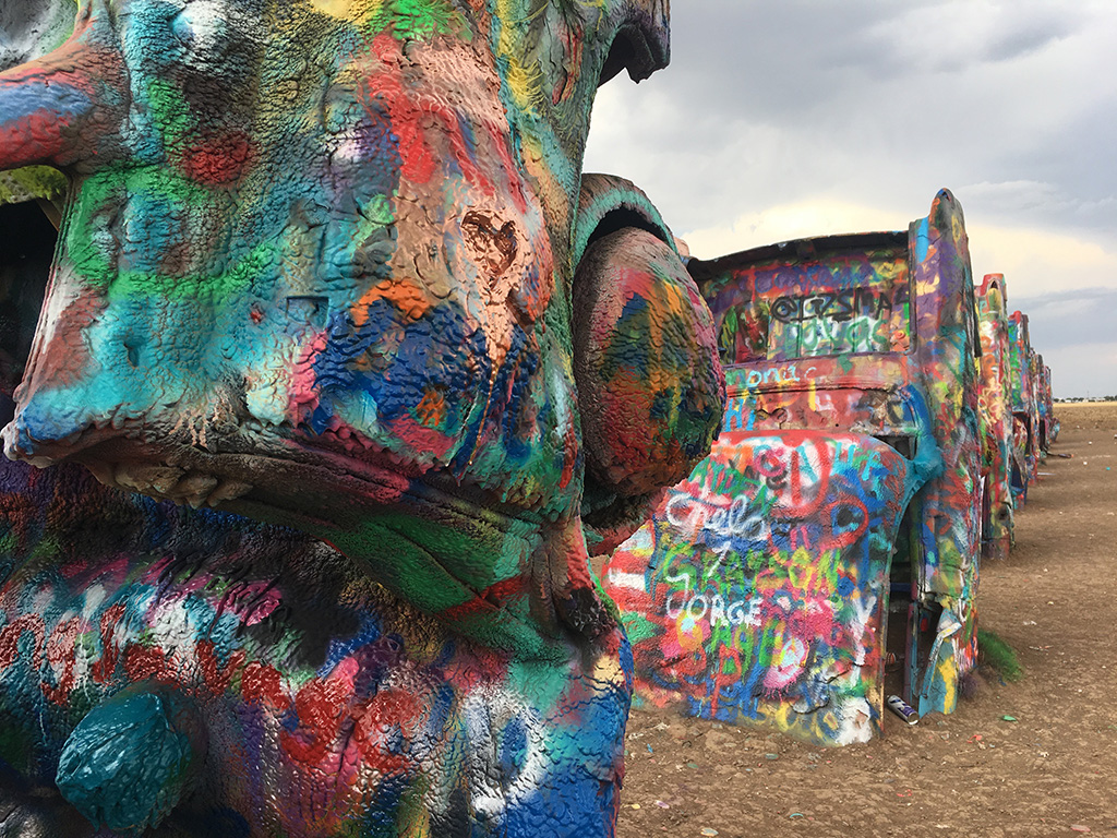 Spray painted cars sprout out of the ground at Cadillac Ranch in Amarillo.