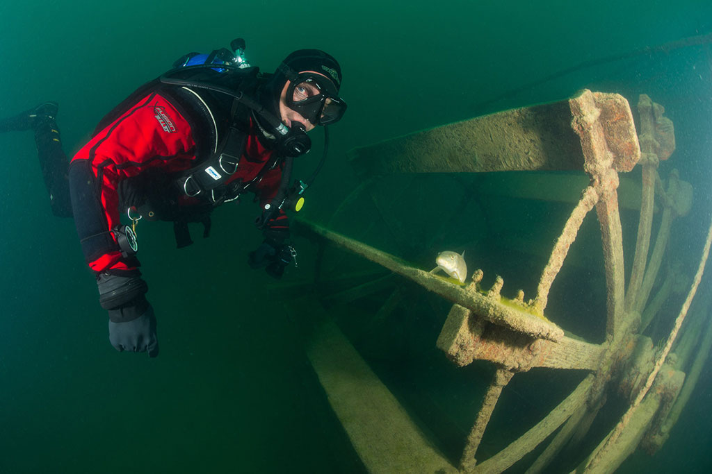Author Bill Streever on a dive next to the paddle wheel of the gold rush era wreck in Lac Laberge.