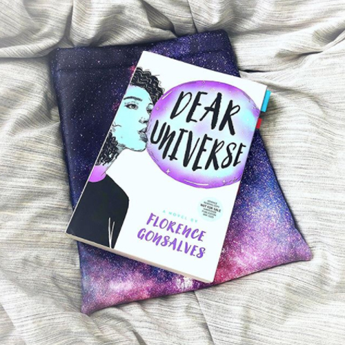 NOVL - Instagram image of book cover for 'Dear Universe' by Florence Gonsalves on top of a universe/galaxy print tablet sleeve