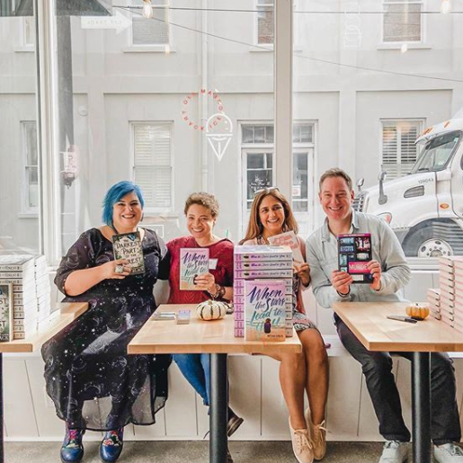 NOVL - Image of 4 authors sitting down at a cafe table at YALLFest 2019