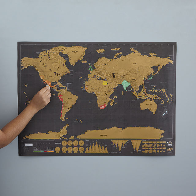 scratch-off world map hanging on a wall