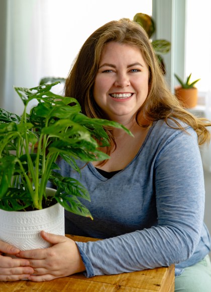 Photo of author Molly Williams holding a potted plant
