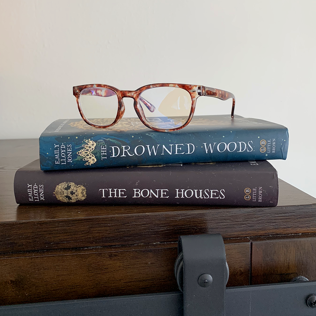 Instagram image of the books "The Bone Houses" and "The Drowned Woods" by Emily Lloyd-Jones