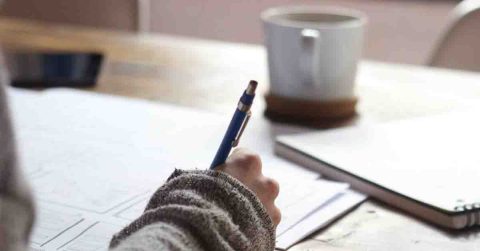 Picture of Person Writing in Notebook