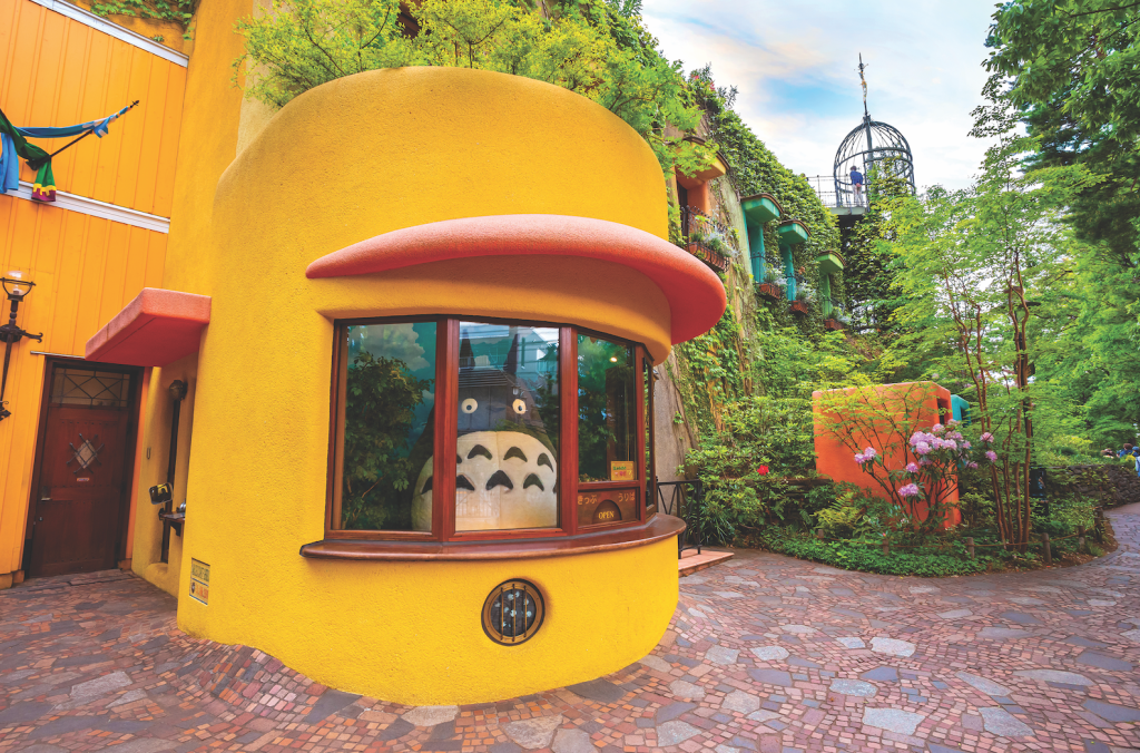 statue of totoro peeking out a window at the Studio Ghibli Museum