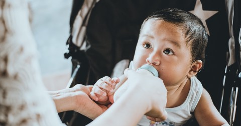 Baby in carriage with bottle