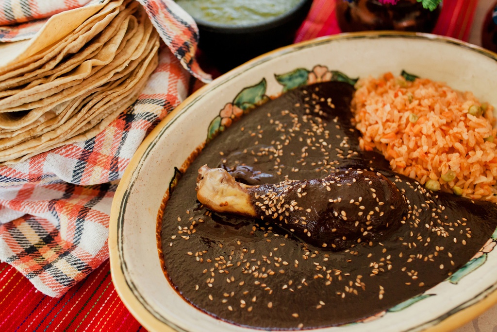 Photo of Mole dish with rice and tortillas