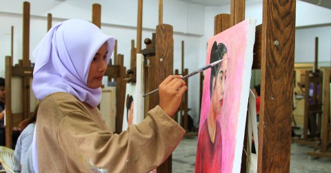 Woman painting on canvas
