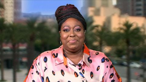 Image of Loni Love sitting and smiling