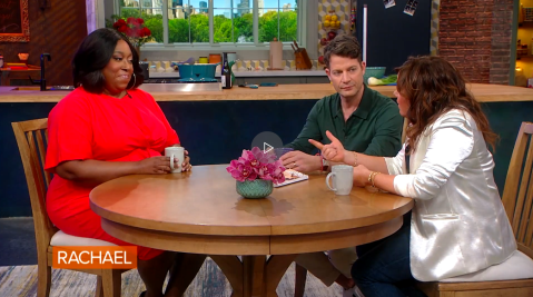 Loni Love on Rachel Ray show sitting at table with hosts