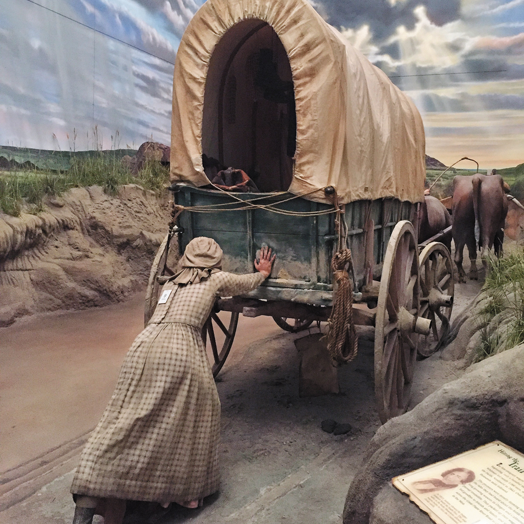exhibit at the archway museum of women pushing cart