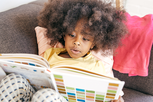 Photo of a toddler reading a book