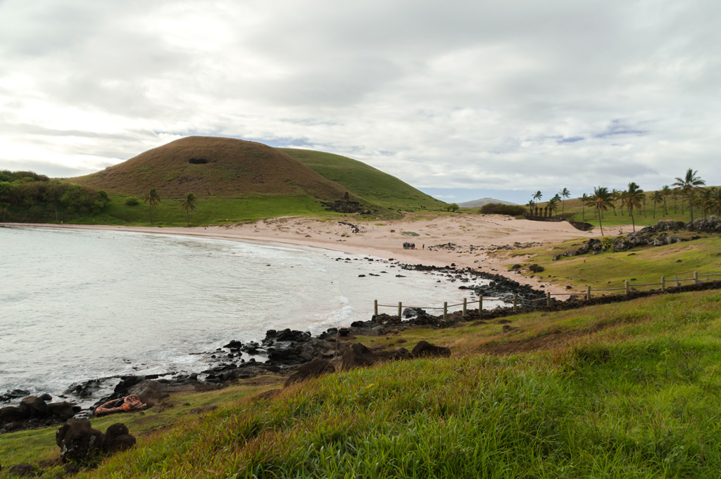 photo of tropical Anakena beach with mounds in the distance