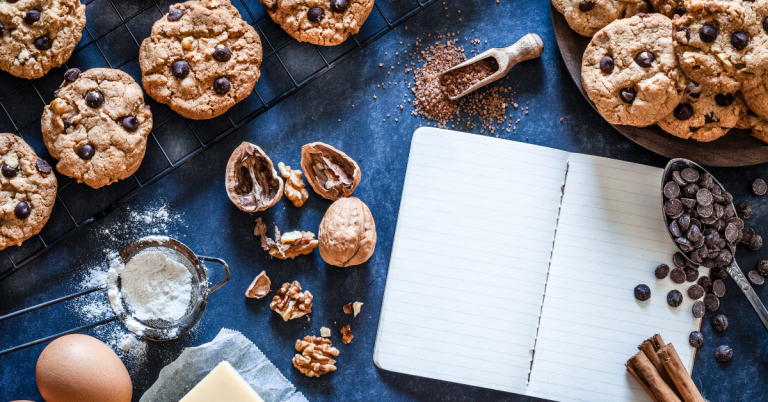 cookies and notebook on a blue table