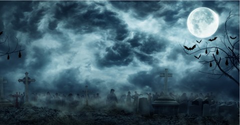 Nighttime full moon cemetery with silhouettes of zombies