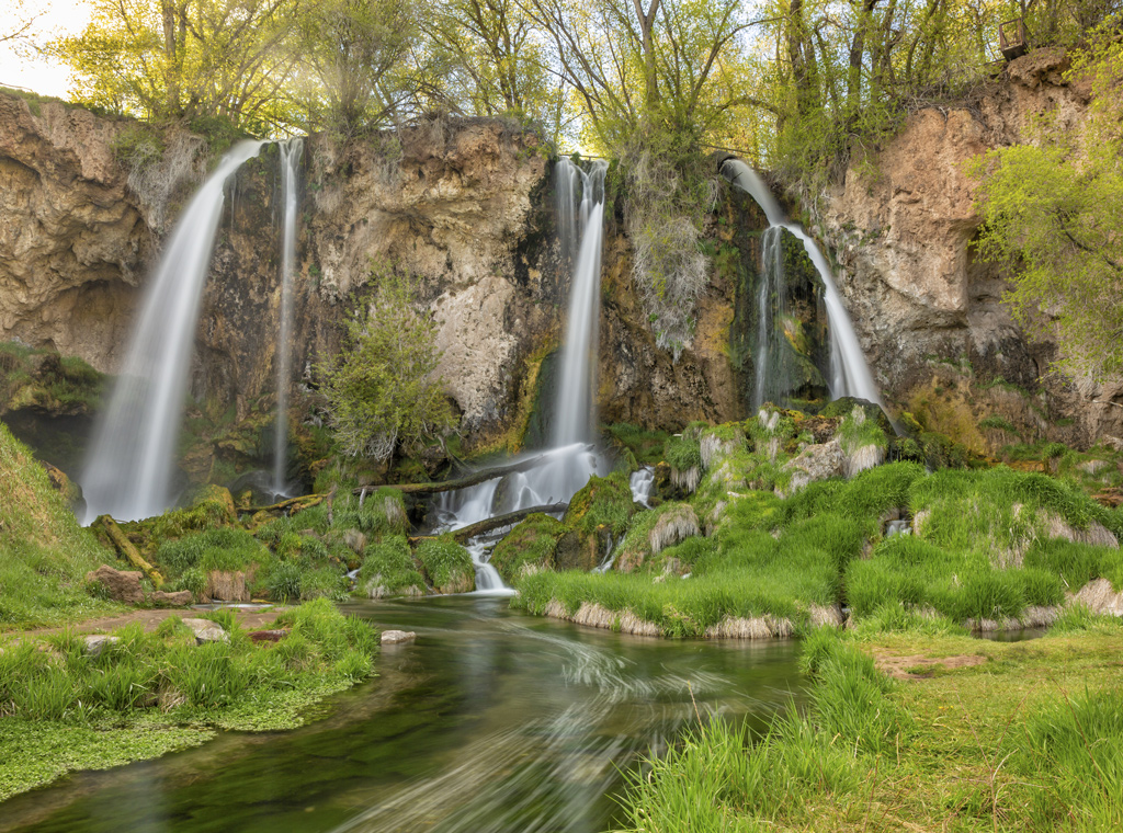 A long exposure of a triple falls at Rifle Falls in the lush Springtime, in Rifle Falls State Park, Colorado.