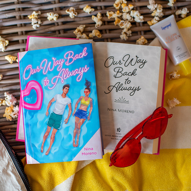 NOVL - Instagram image of book cover for 'Our Way Back to Always' by Nina Moreno surrounded by popcorn, a beach towel, sunglasses and sunscreen