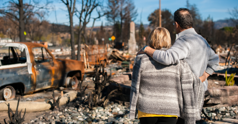 couple in front of wreckage