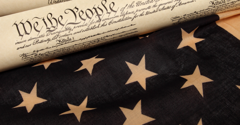 Image of the Constitution sitting on American flag