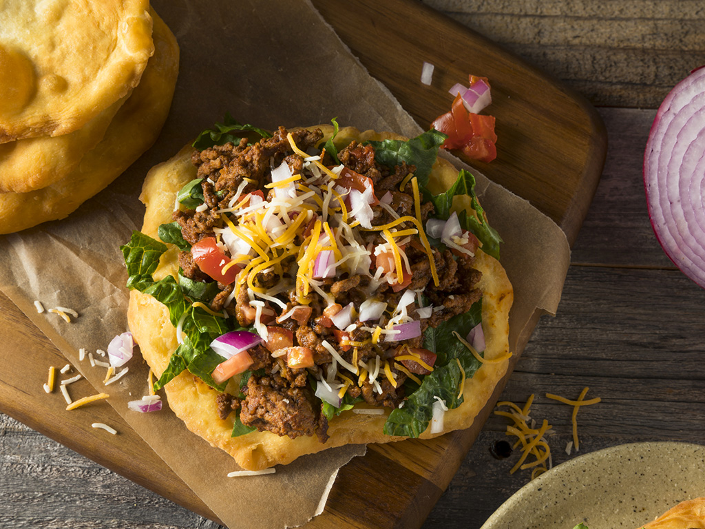 a fry bread taco on a table