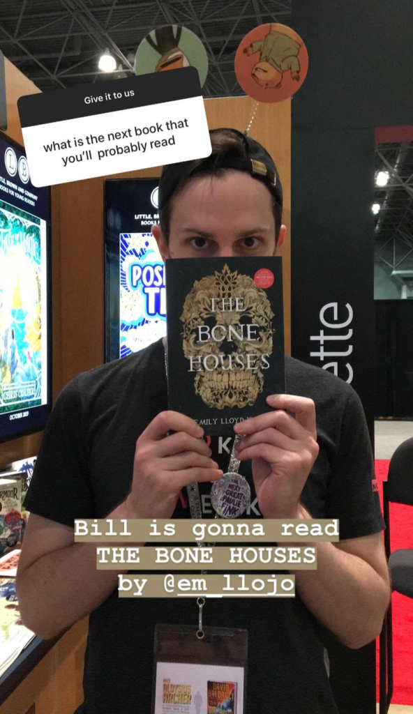 NOVL - Bill holding up 'The Bone Houses' in front of his face