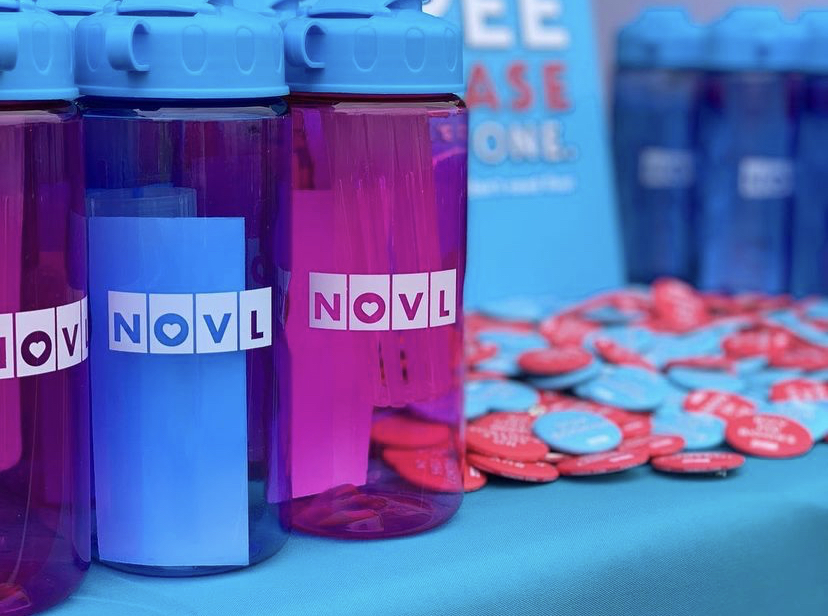 NOVL - Image of NOVL branded water bottles and pins at the NOVL booth