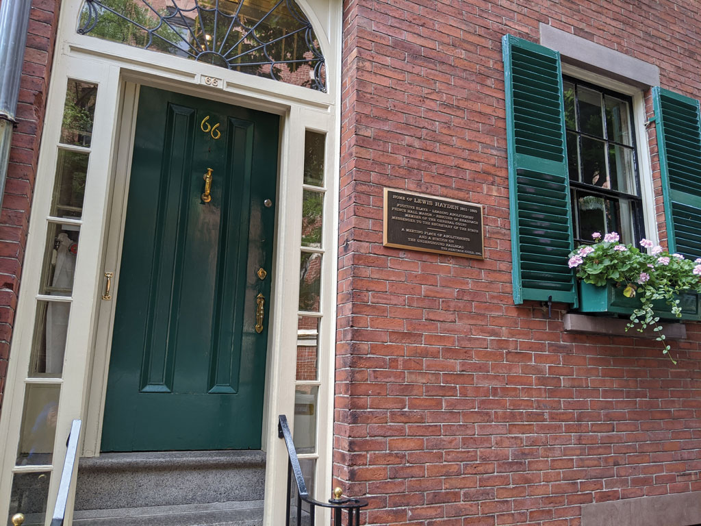 green door in a red brick building with a plaque that says hayden house