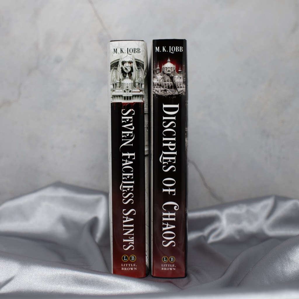 Image of the hardcover spines of 'Seven Faceless Saints' and 'Disciples of Chaos' by M. K. Lobb