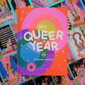 Photo of "My Queer Year" laid above face-up cards from the "Queer Tarot" deck