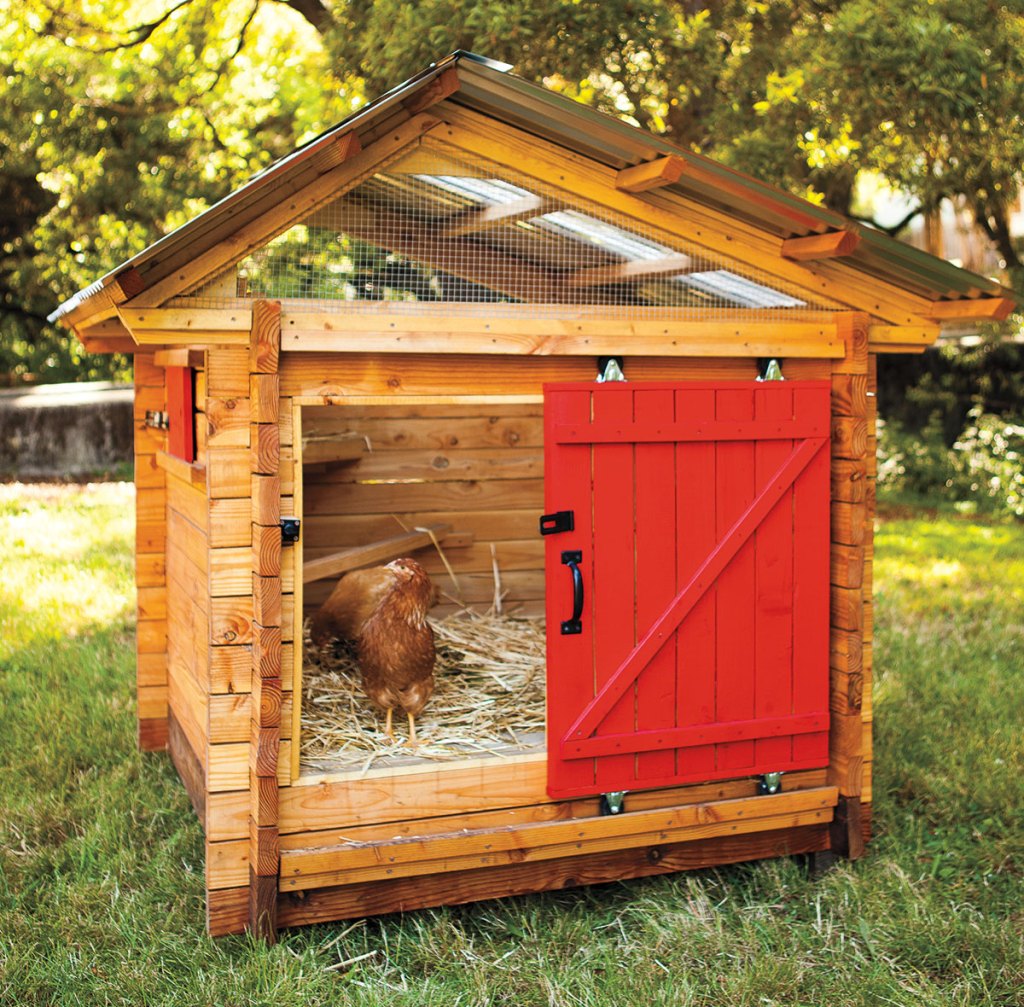 Photo of a small chicken coop with a red slider door