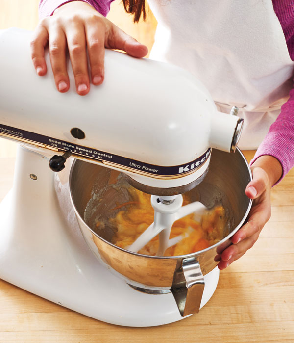 Photo of eggs and sugar mixing in a stand mixer.