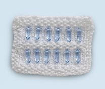 Photo of a white knit rectangle with blue crystal beads.