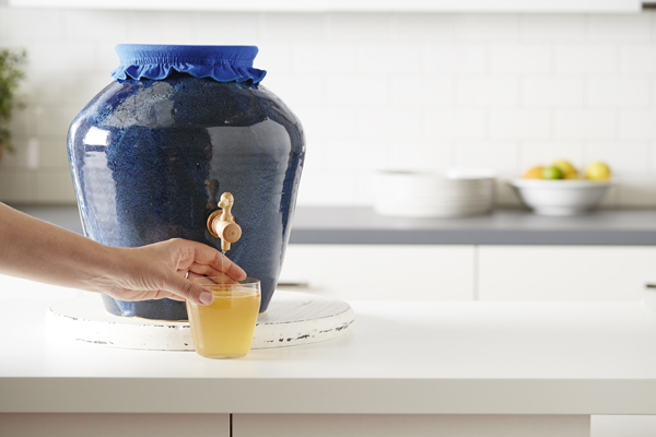 Photo of a Kombucha in a large blue pitcher with spout.