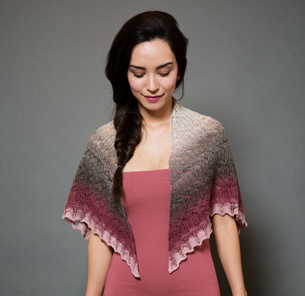 Photo of a woman wearing a small knit shall with a beaded border around her shoulders.