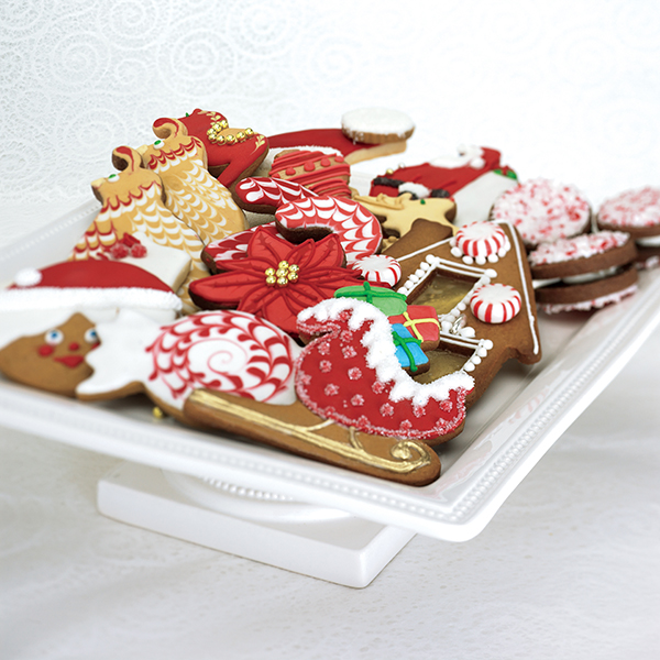 Photo of a tray of Christmas-themed decorated cookies.
