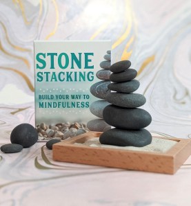 Photo of the "Stone Stacking" box and included stones, wooden tray, and sand
