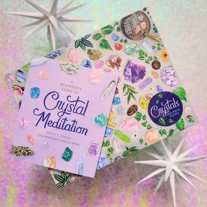 Photo of the "Crystals 500-Piece Puzzle" box, with the included mini book laid on top of it.