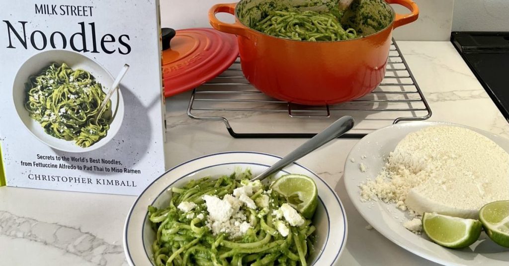 Photo of a bowl of pasta next to the book MILK STREET NOODLES
